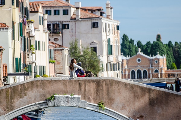 venice flooding sitting on a bridge